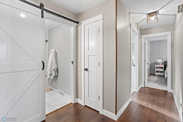 bathroom featuring wood-type flooring and a textured ceiling