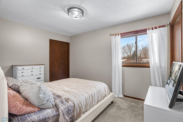 carpeted bedroom featuring a textured ceiling