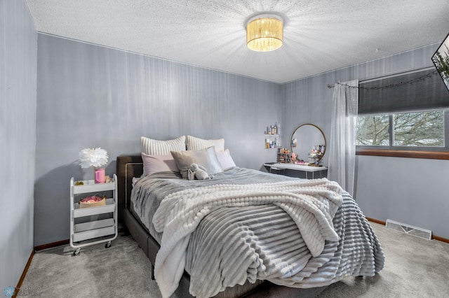 bedroom featuring carpet and a textured ceiling