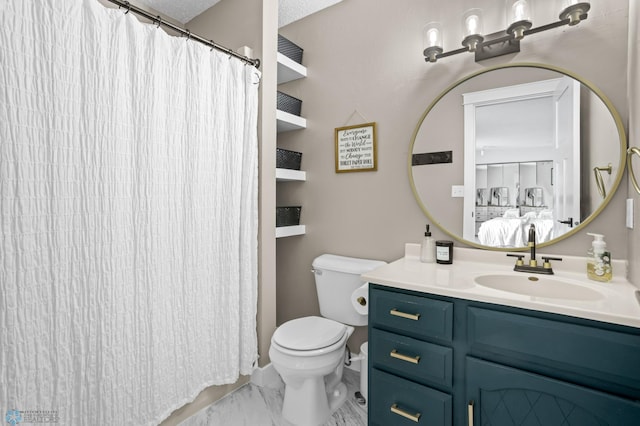 bathroom with a textured ceiling, vanity, and toilet