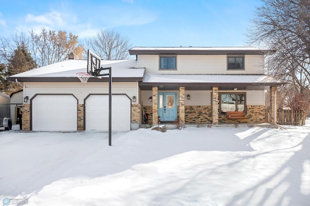 front of property featuring covered porch and a garage