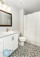 bathroom featuring vanity, toilet, and a shower with shower curtain