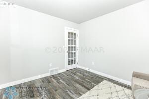 unfurnished room featuring dark hardwood / wood-style flooring