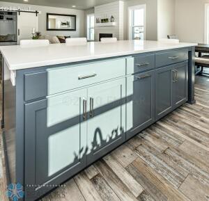 kitchen with hardwood / wood-style flooring, a large fireplace, and a kitchen island