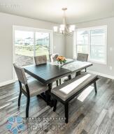 dining area with a chandelier and dark wood-type flooring