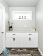 bar with white cabinetry and dark hardwood / wood-style floors