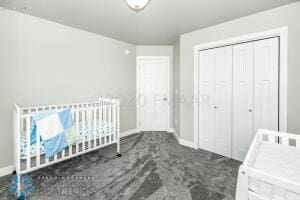 unfurnished bedroom featuring dark carpet and a closet