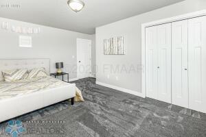 bedroom featuring dark colored carpet and a closet