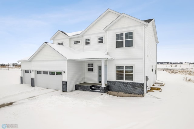 view of front of house featuring a garage and brick siding
