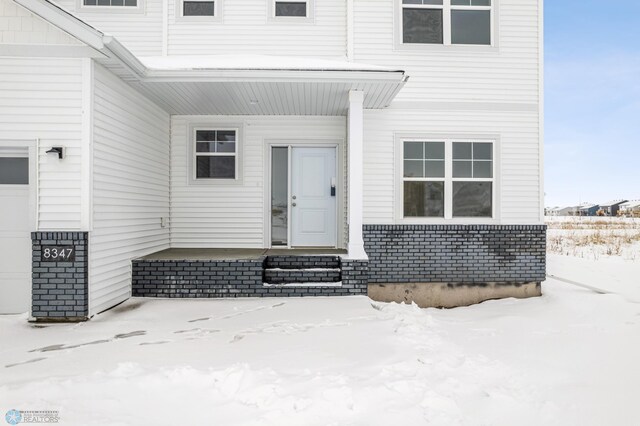 view of snow covered property entrance