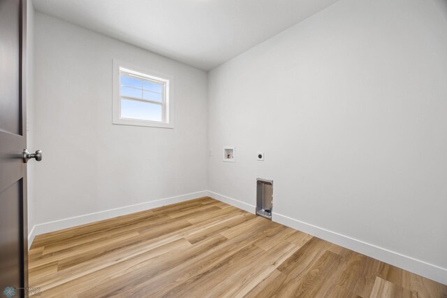 clothes washing area featuring electric dryer hookup, light wood-style flooring, laundry area, baseboards, and hookup for a washing machine