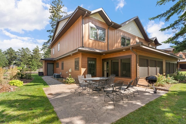 back of property featuring a lawn, a patio, and central AC unit