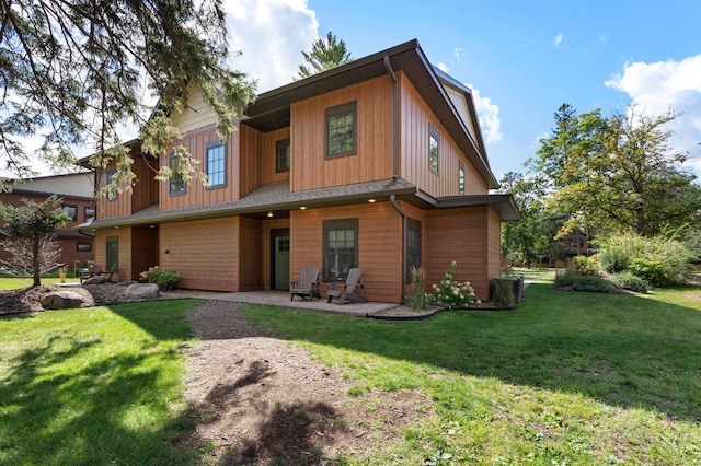 back of house featuring a yard and a patio