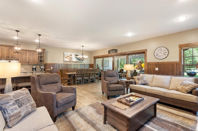 living room with a notable chandelier and light wood-type flooring