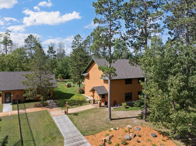 exterior space with a patio area and a front lawn