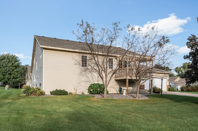 view of front facade with a front yard, a garage, and a deck