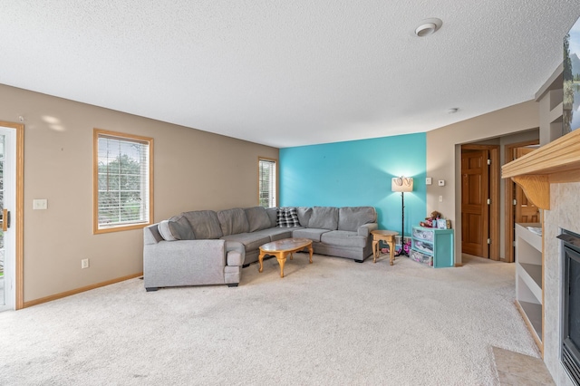 carpeted living room featuring a textured ceiling and a fireplace