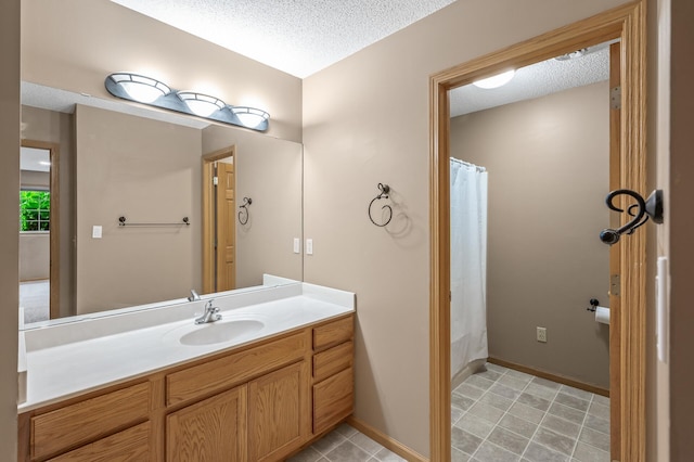 bathroom featuring vanity, tile patterned flooring, a textured ceiling, and a shower with shower curtain