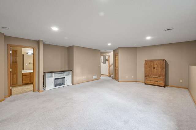 unfurnished living room with light colored carpet