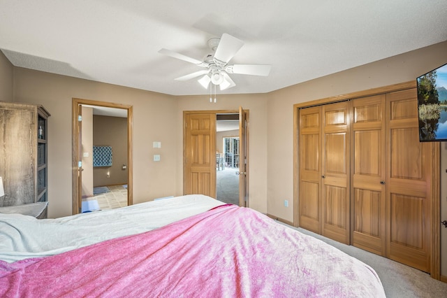 bedroom featuring ensuite bathroom, ceiling fan, and light colored carpet