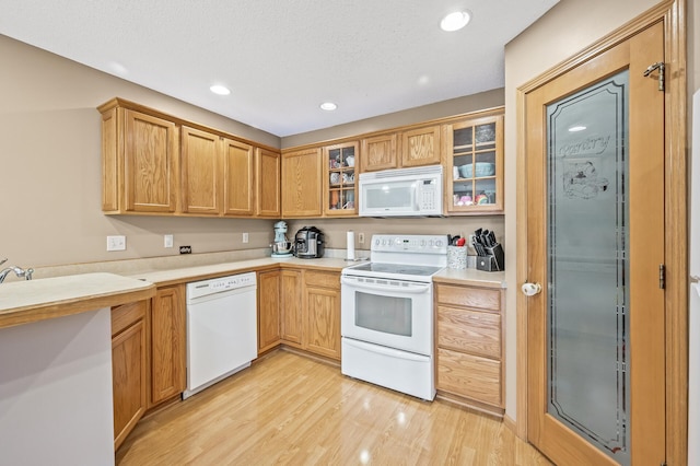 kitchen featuring light hardwood / wood-style flooring and white appliances