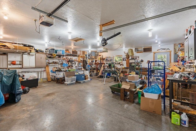 garage with a garage door opener and a workshop area