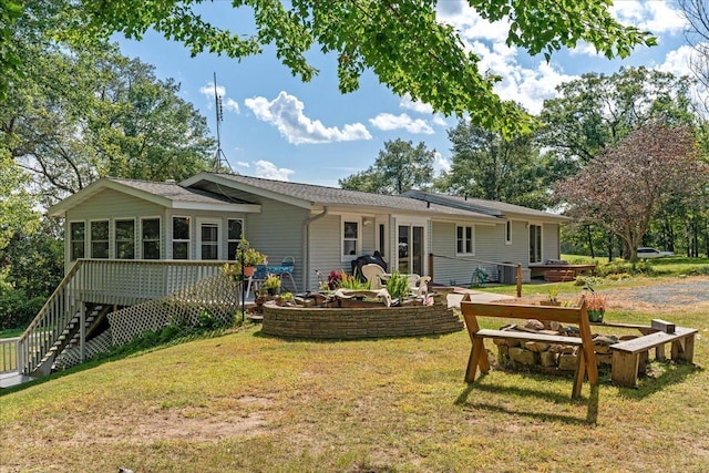 back of property with a yard, a sunroom, and central air condition unit