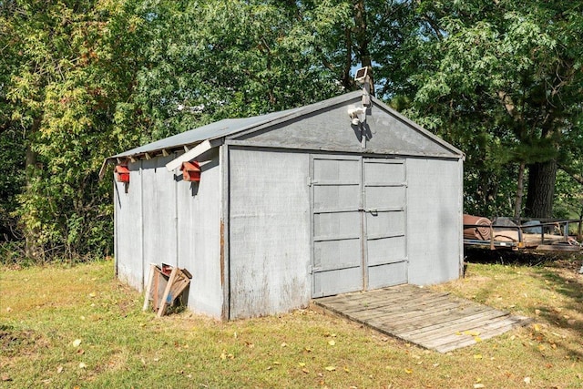 view of outdoor structure with a lawn