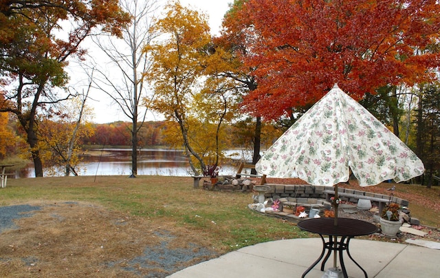 view of yard with a patio and a water view