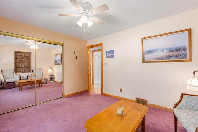 living area with carpet floors, built in features, and ceiling fan