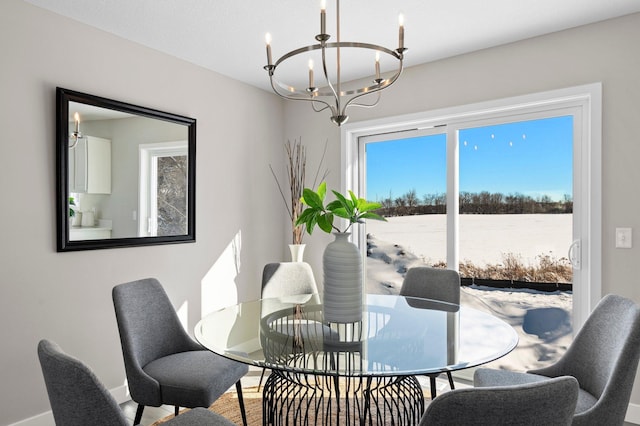 dining space with a water view and a notable chandelier