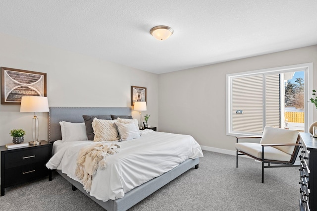 bedroom featuring a textured ceiling and carpet floors