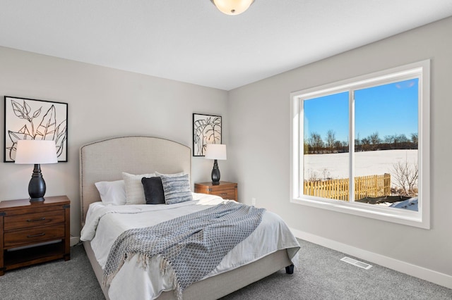 bedroom with multiple windows and carpet