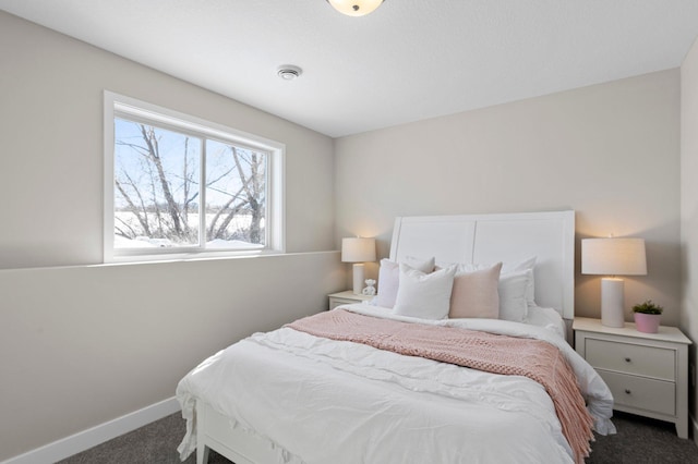 bedroom featuring dark colored carpet