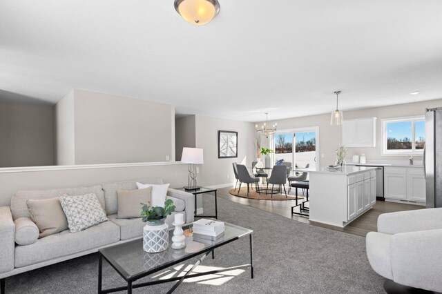 living room with a notable chandelier and light hardwood / wood-style floors