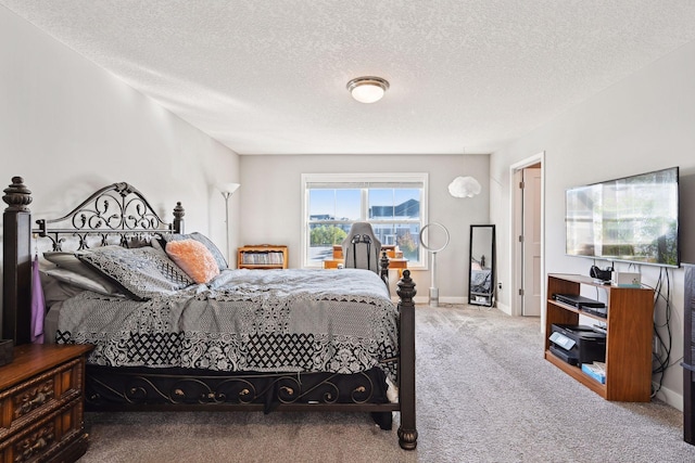 bedroom with carpet floors and a textured ceiling