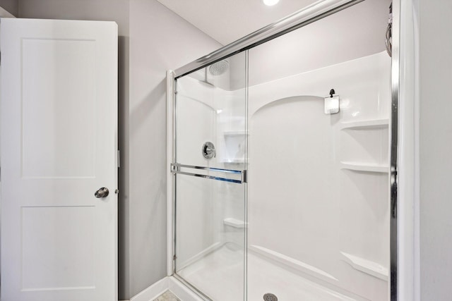 bathroom with a shower with shower door