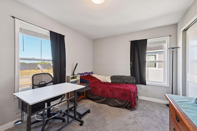 carpeted bedroom with a textured ceiling