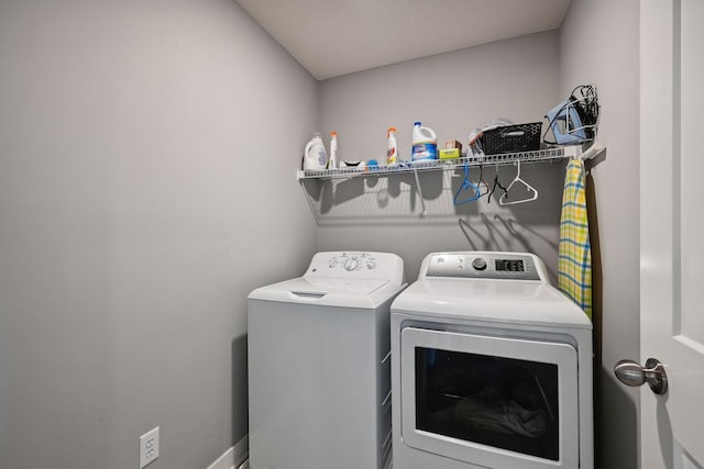 clothes washing area featuring washer and clothes dryer