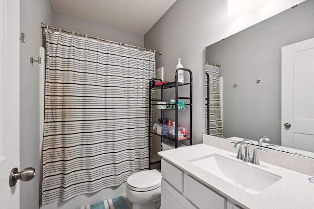 bathroom with vanity, a textured ceiling, and toilet