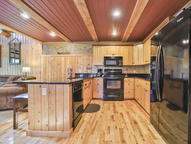 kitchen with black appliances, light brown cabinetry, sink, and light hardwood / wood-style floors