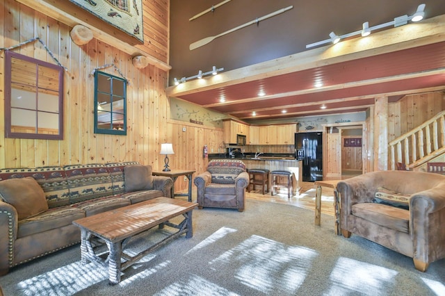 living room featuring a high ceiling and wood walls