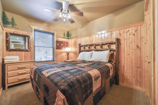 carpeted bedroom with ceiling fan and wooden walls