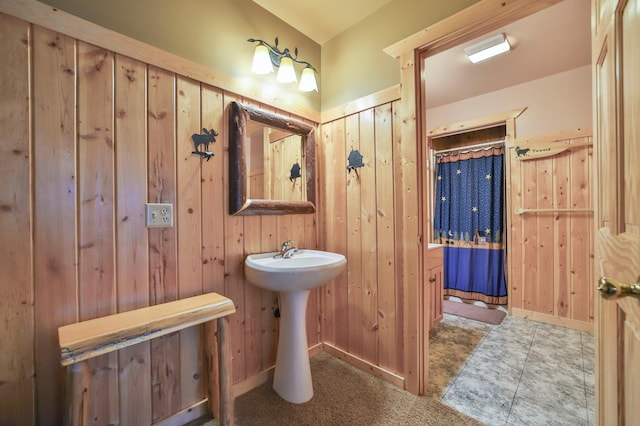 bathroom featuring wooden walls and tile patterned floors