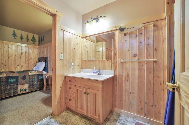 bathroom featuring wood walls and vanity