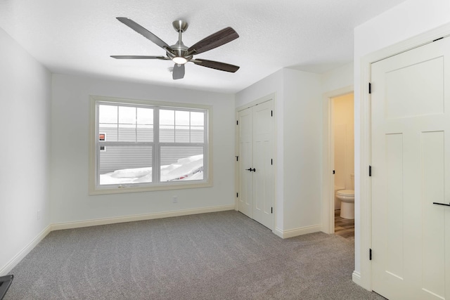 spare room featuring light carpet, a textured ceiling, and ceiling fan