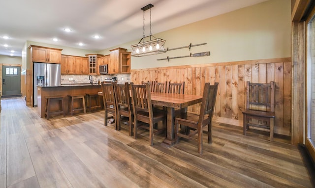 dining room with wood walls and dark hardwood / wood-style floors