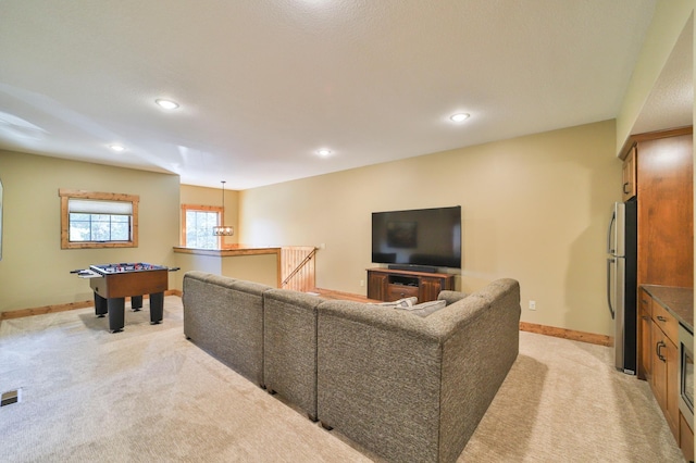 living room featuring light colored carpet, baseboards, visible vents, and recessed lighting