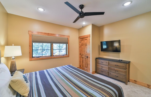 carpeted bedroom featuring baseboards, ceiling fan, and recessed lighting