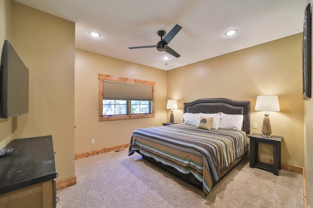 bedroom with ceiling fan and light carpet